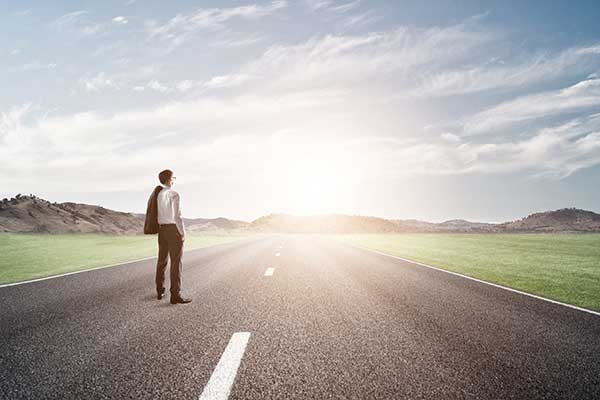 Man Looking Down Road